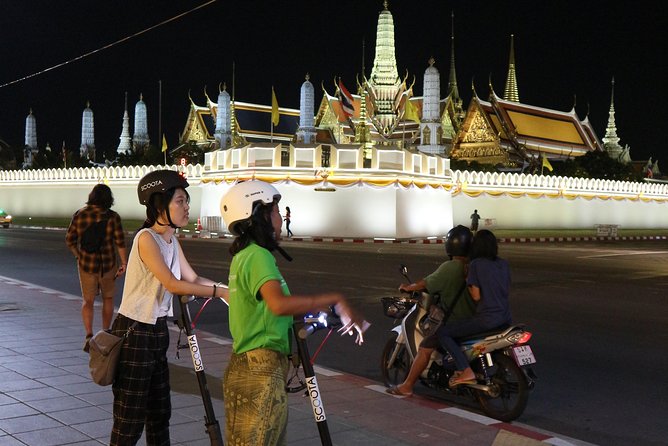 Bangkok at Night by Electric Scooter - The Grand Palace lit up from the street